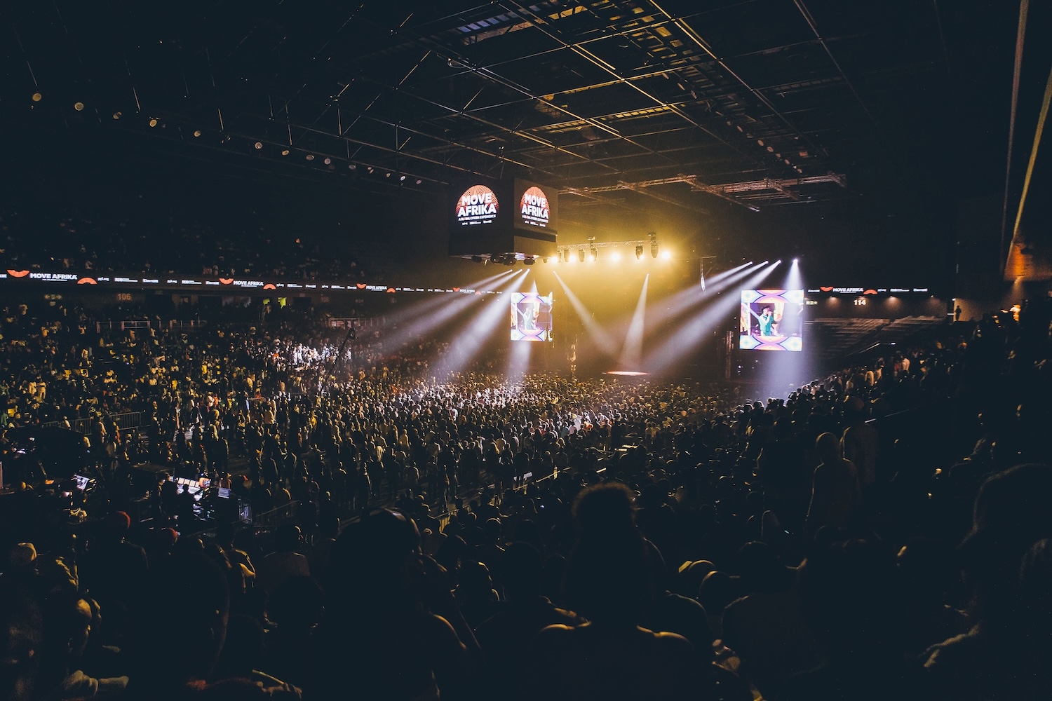 BK Arena in Kigali filled with action-taking audience members, 2023.