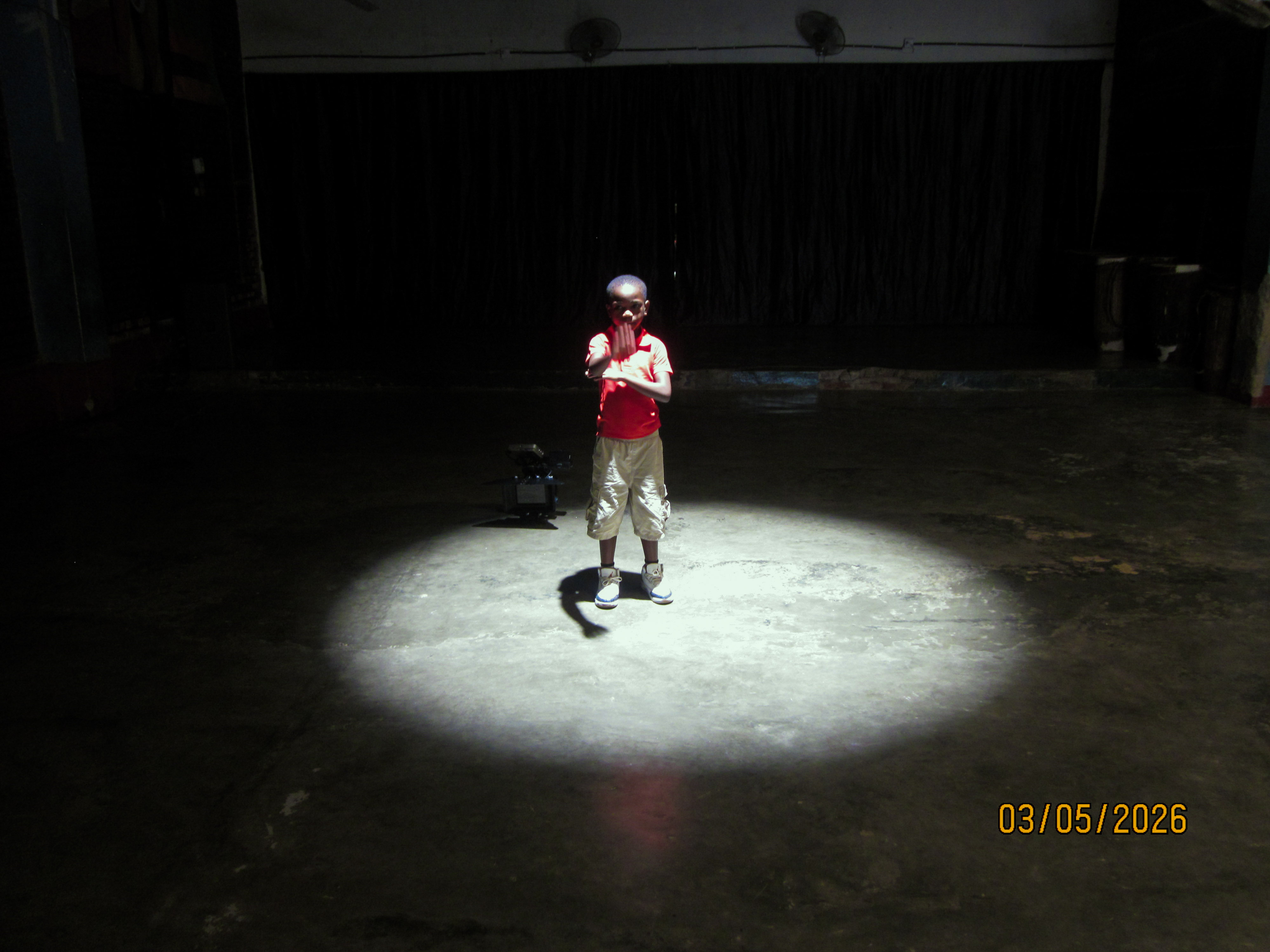 A young performer stands under a spotlight during a rehearsal in Kigali, Rwanda. Through mentorship and professional training, the Sherrie Silver Foundation helps young artists pursue careers in the creative industries. Image: Jordan Hidalgo