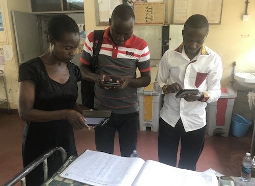 Fieldworkers extracting data from paper based hospital records (1).jpg