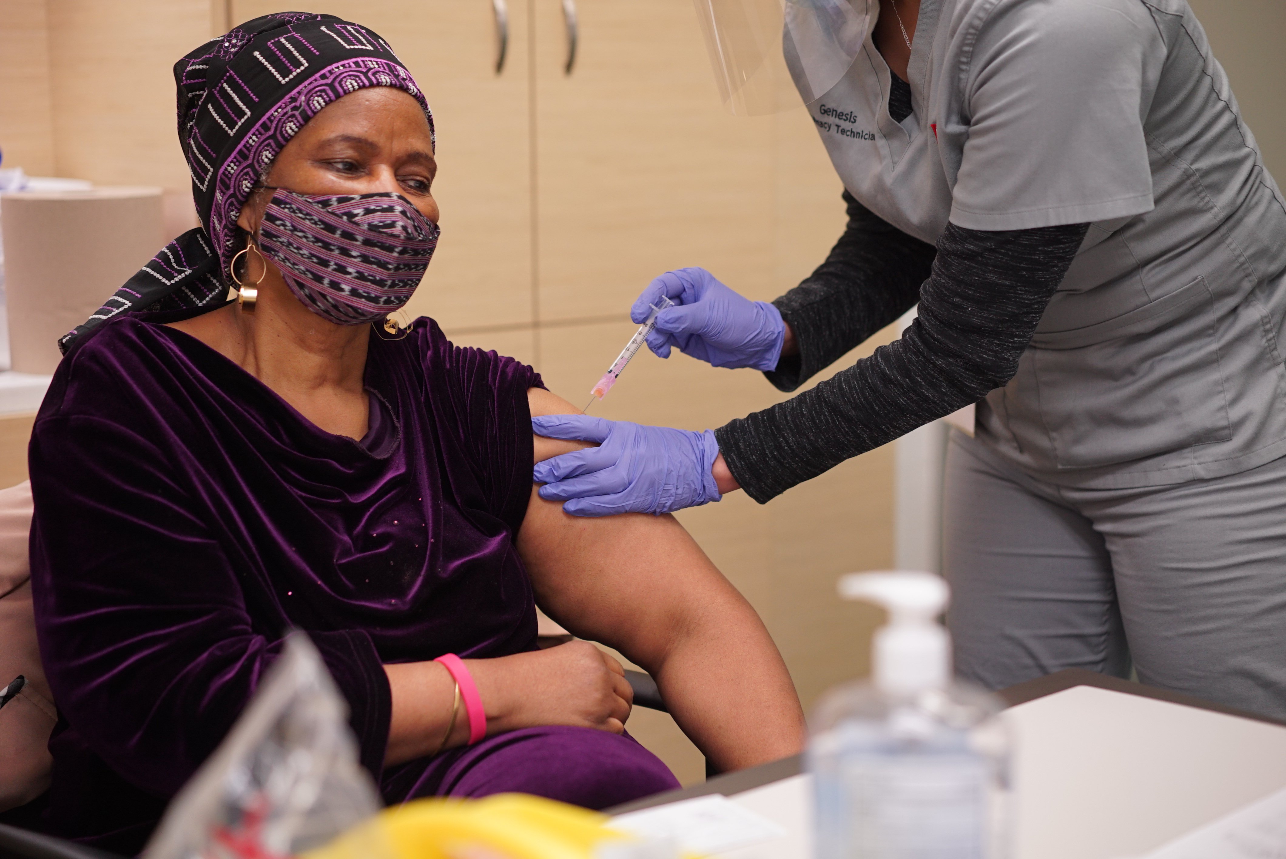 A nurse gives UN Women executive director, Phumzile Mlambo Ngcuka her first dose of the COVID-19 Vaccine.