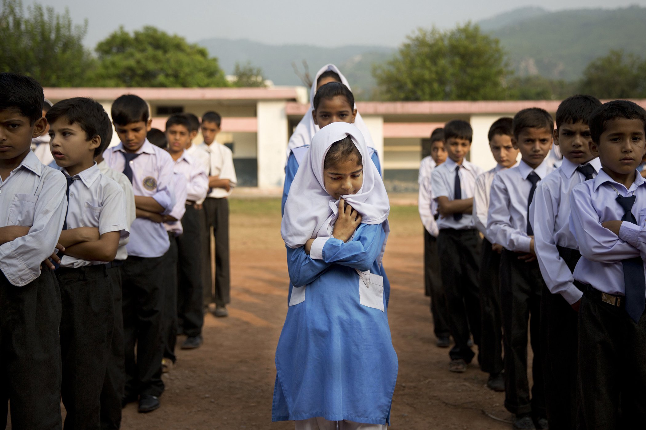 A Pakistani girl lines up among boys for their morning assembly where they sing the national anthem at a school in Islamabad, Pakistan, on Oct. 11, 2013. In Pakistan, the Taliban stops more than 25 million children from going to school.
