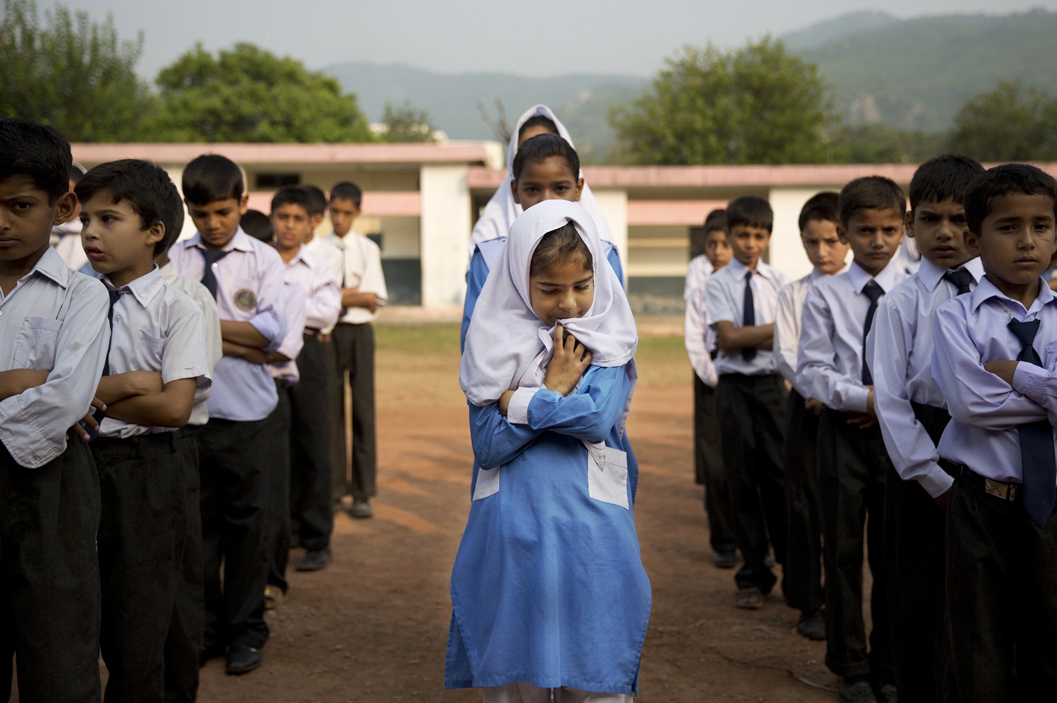 A Pakistani girl lines up among boys for their morning assembly where they sing the national anthem at a school in Islamabad, Pakistan, on Oct. 11, 2013. In Pakistan, the Taliban stops more than 25 million children from going to school. Barriers-To-Education-Around-The-World-2.jpg